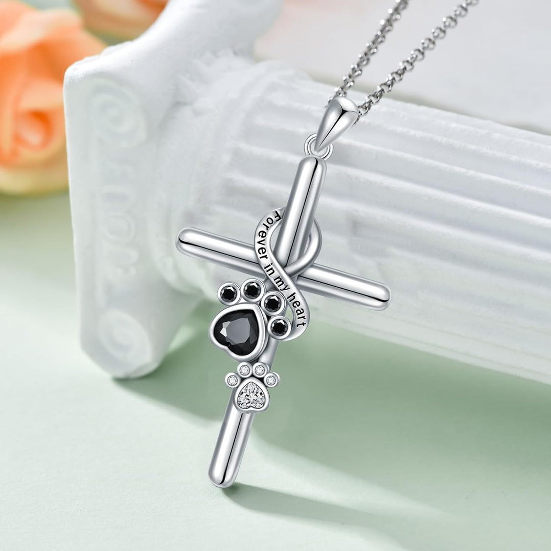 Silver paw print and cross pendant