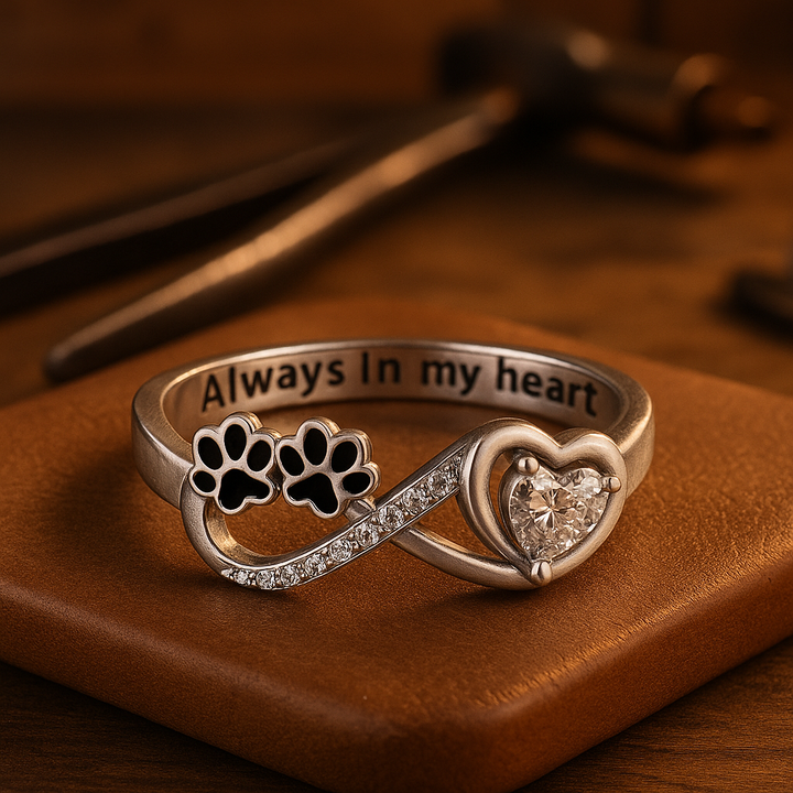 Ring with paw-shaped zirconia, heart, and infinity symbol