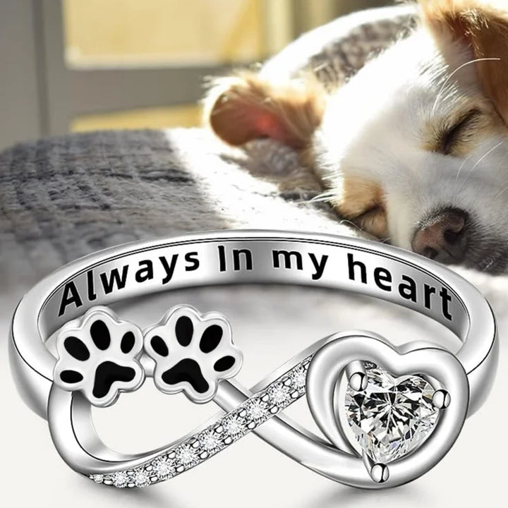 Ring with paw-shaped zirconia, heart, and infinity symbol