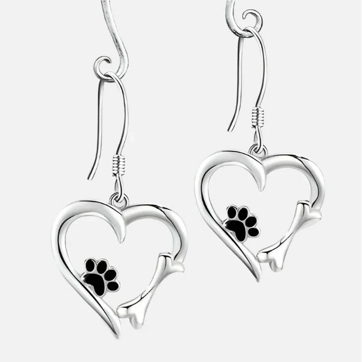 Silver dangling earrings with a heart and paw print design
