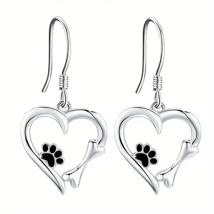 Silver dangling earrings with a heart and paw print design