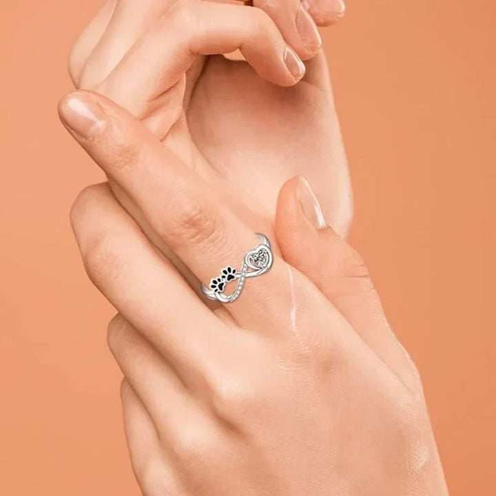 Ring with paw-shaped zirconia, heart, and infinity symbol